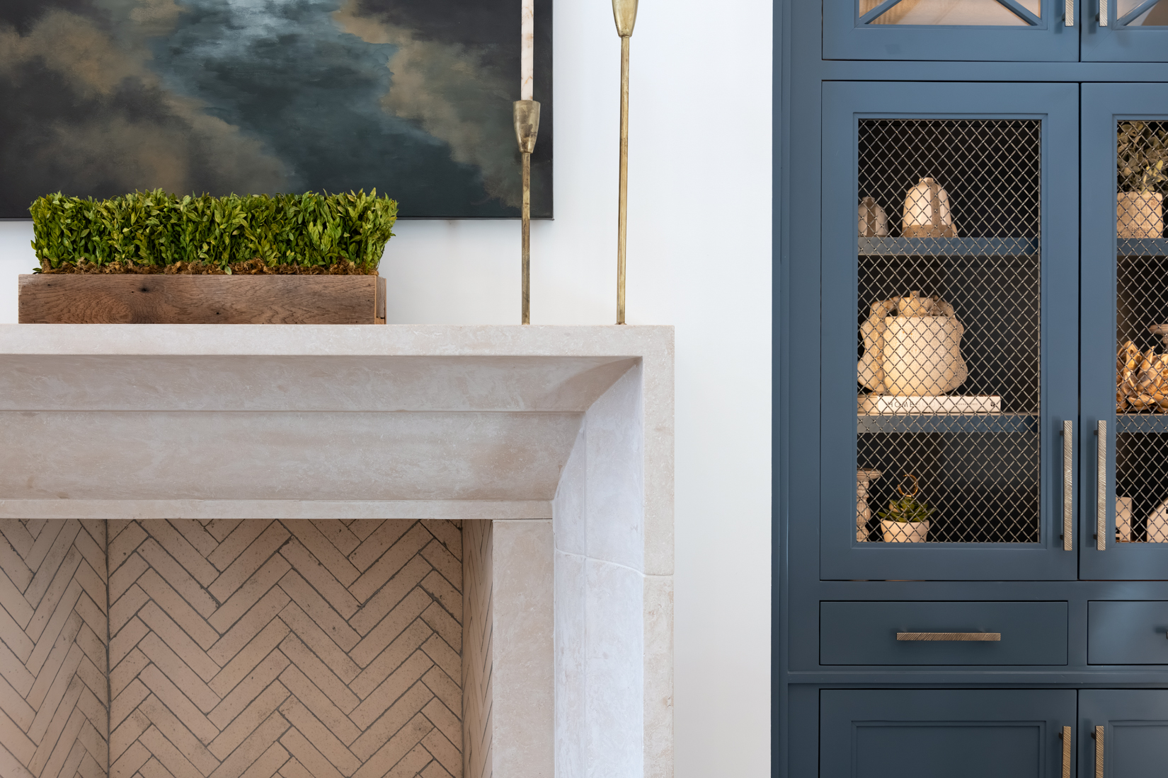 A beautifully styled kitchen with marble counters and brass fixtures